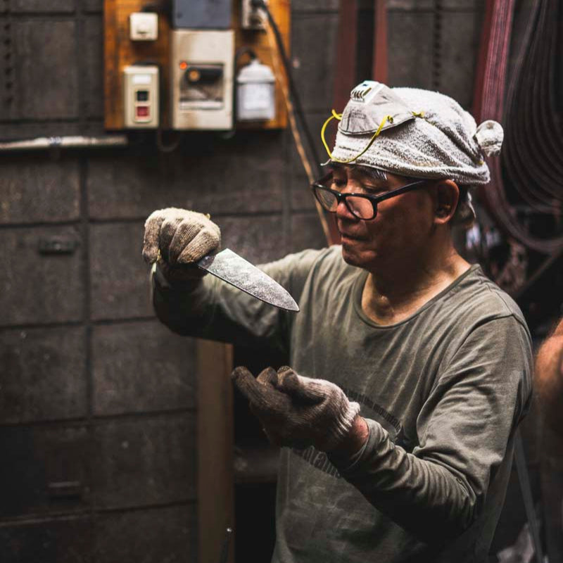 Blacksmith checking his work